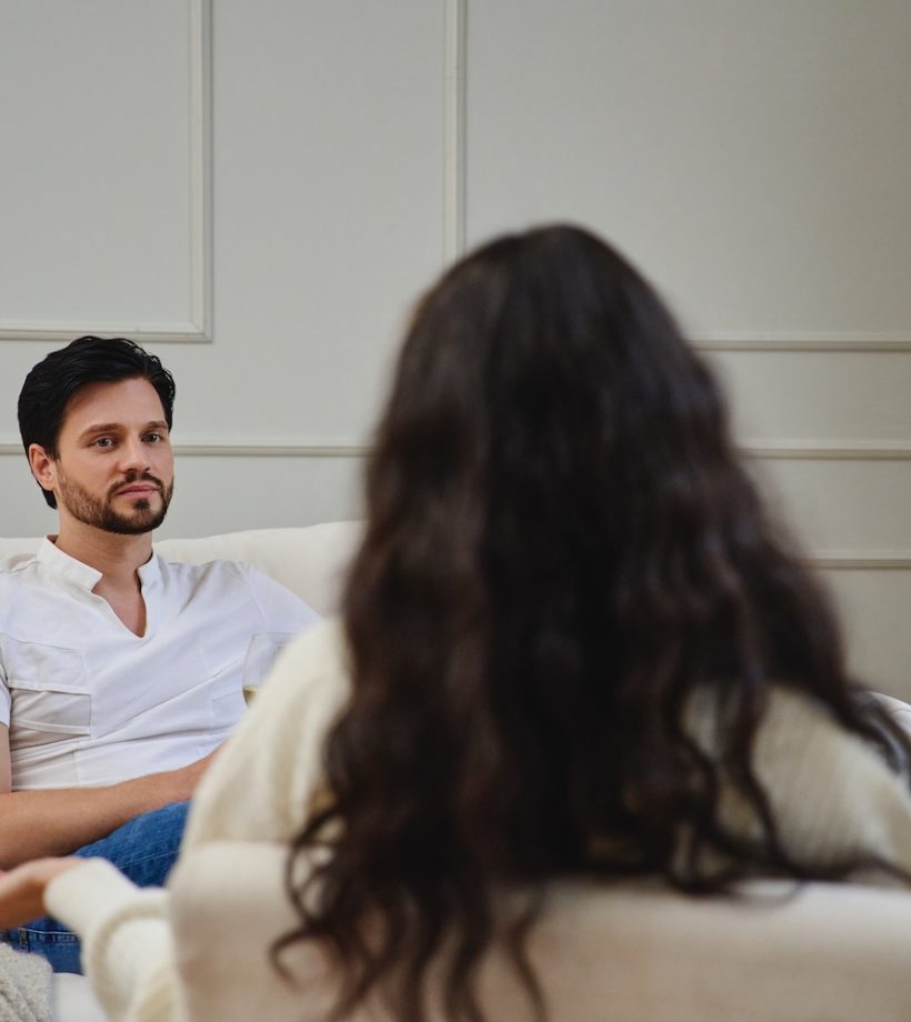 Two individuals engage in an important discussion in a warm room.