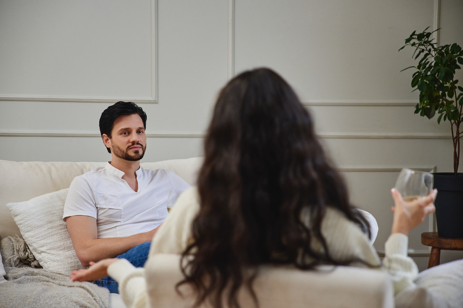 Two individuals engage in an important discussion in a warm room.